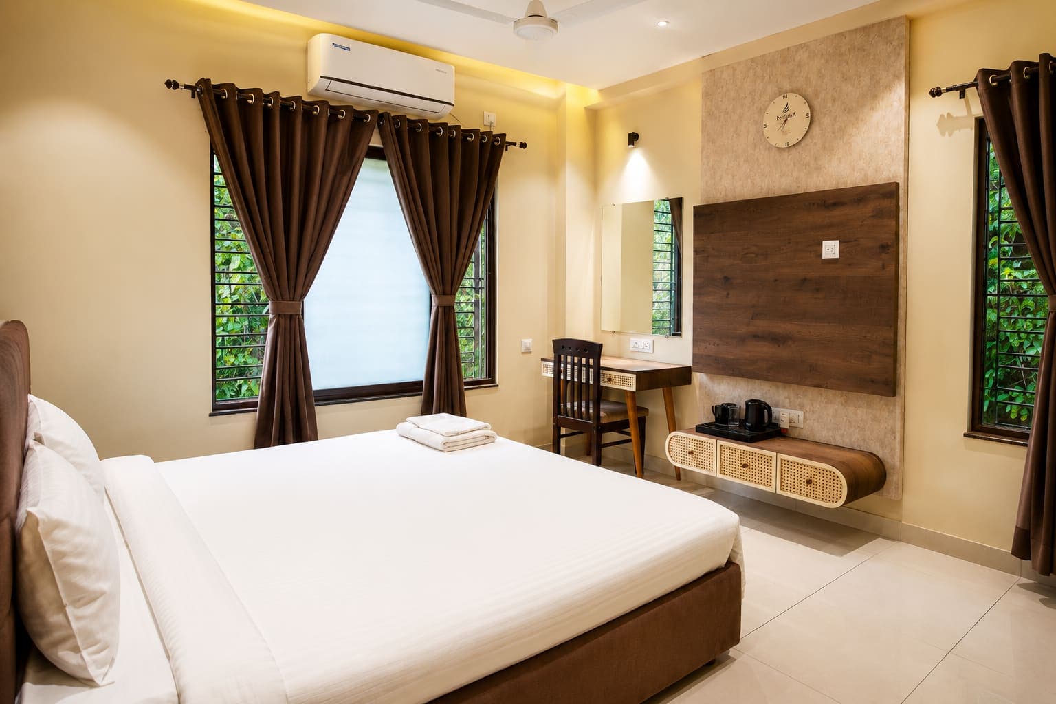 Guest bedroom with king bed, work desk and air conditioning