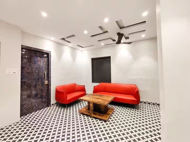 Lounge seating with red sofas at an INSATA property